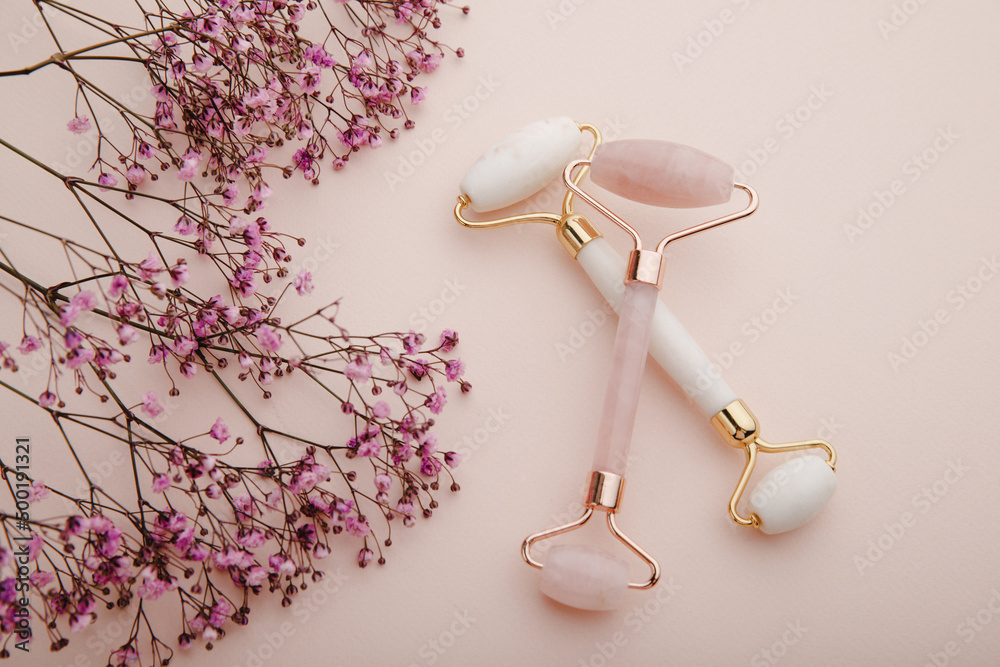 Face massage rollers on a pink background. Spa and beauty care concept
