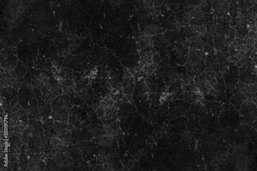 Cracked dark concrete plaster wall surface with heavy grunge texture for background
