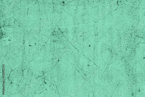 Scattered grunge textured teal color old concrete wall for background