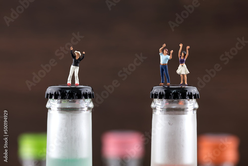 Cheering alcoholic on creative wine bottle in miniature