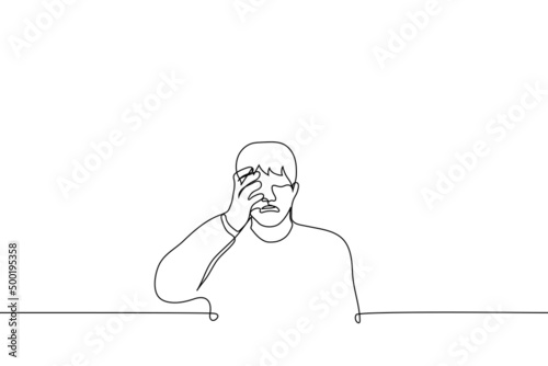 man crying holding his face - one line drawing vector. the concept of desperate crying, male crying sobbing, hysteria photo