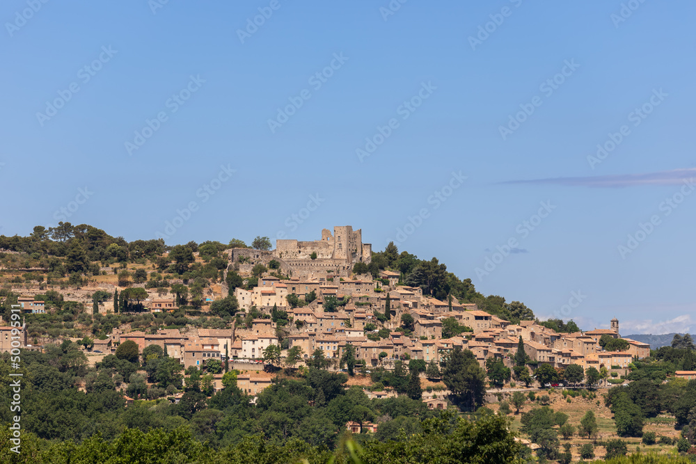 Fototapeta premium Medieval historic Lacoste village stands on hilltop of Little Luberon massif with ruins Marquis de Sade castle. Vaucluse, Provence, France