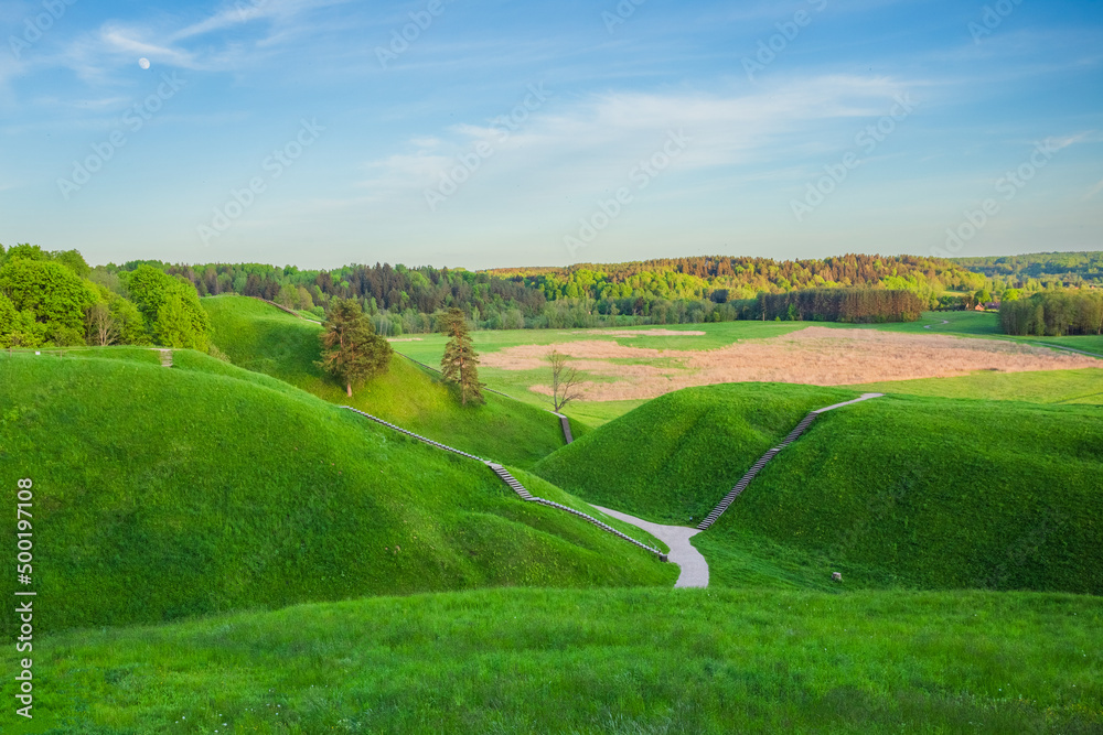 Obraz premium Kernave at spring, green mounds at historic capital in Lithuania