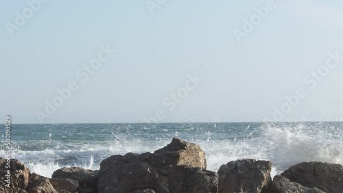 Waves sea jumping above the rocks photo