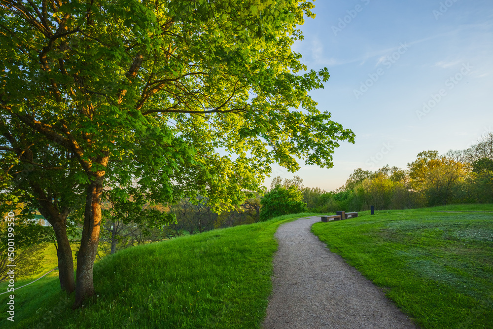 Naklejka premium Kernave at spring, green mounds at historic capital in Lithuania