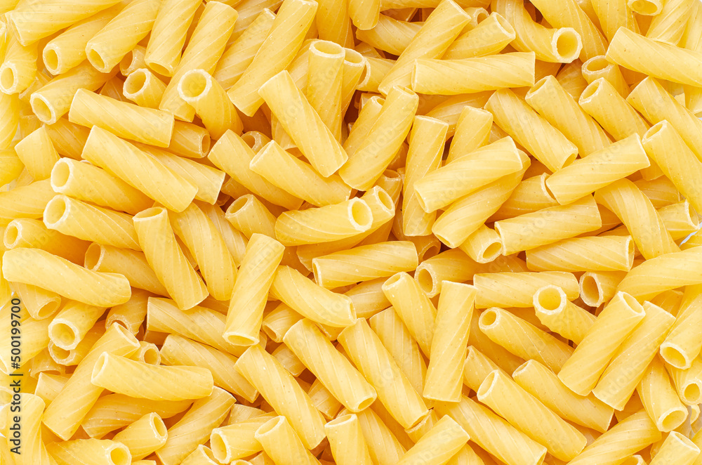 Raw pasta. Food background. An ingredient for traditional Italian food. Closeup Raw pasta. Food background. An ingredient for traditional Italian food. Closeup