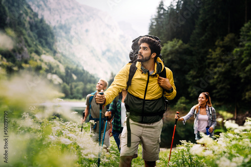 Group of fit healthy friends trekking in the mountains