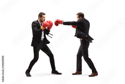 Full length profilr shot of businessmen fghting with boxing gloves