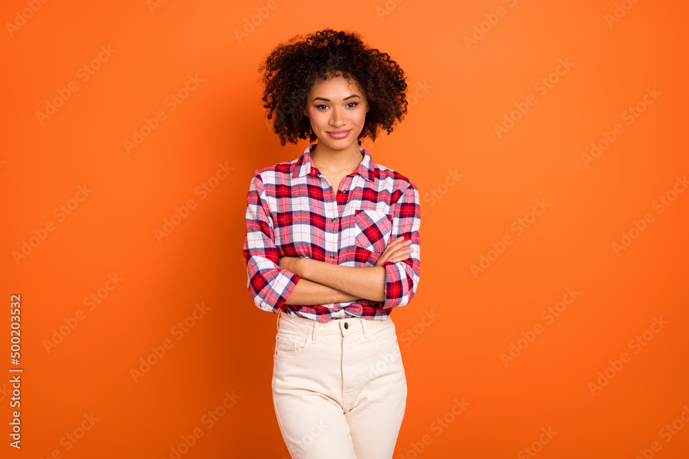 Portrait of attractive cheerful brown-haired content girl folded arms isolated over bright orange color background Portrait of attractive cheerful brown-haired content girl folded arms isolated over bright orange color background