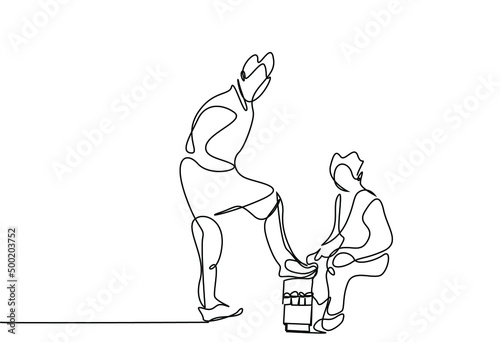 a boy is doing the old-timey shoe shine polishing and painting job and a person hands him his shoes