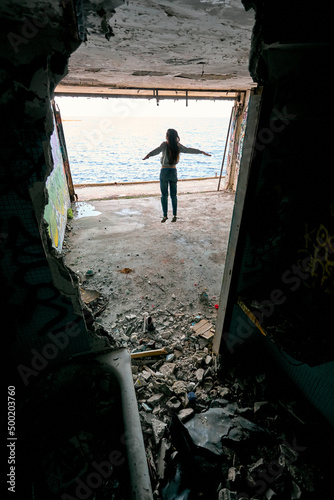 girls dream to fly over the sea and jump in ruined building