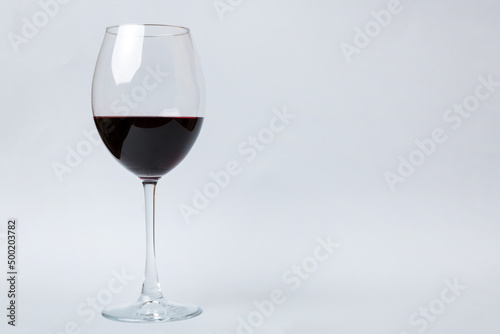 One glasses of red wine at wine tasting. Concept of red wine on colored background. Top view, flat lay design