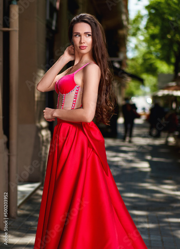 beautiful girl in a red dress on the street © JENOCHE