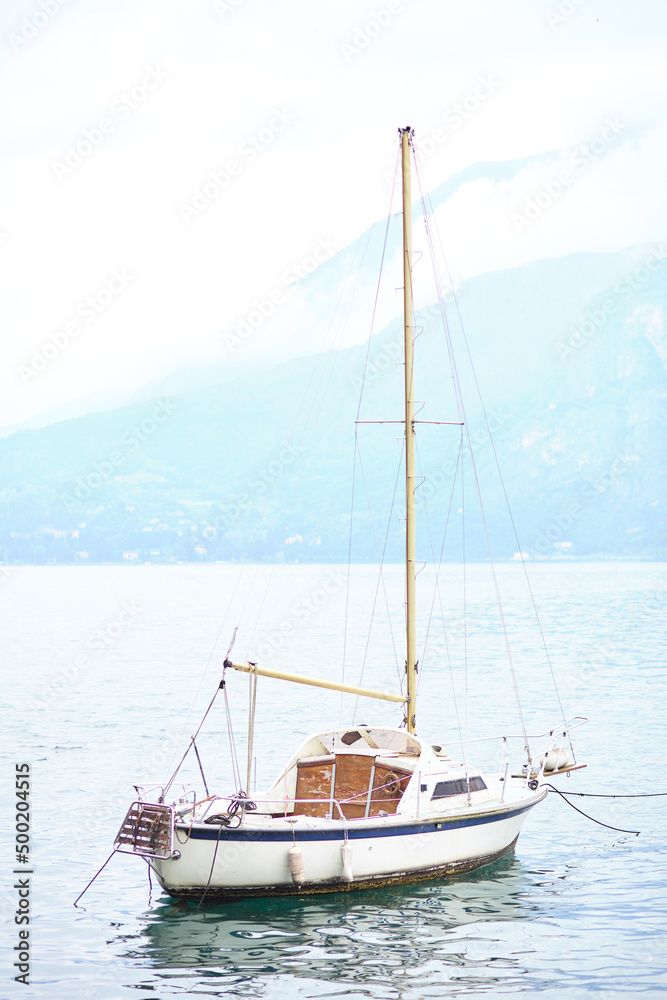 sailboat on the shore of a mountain lake sailboat on the shore of a mountain lake