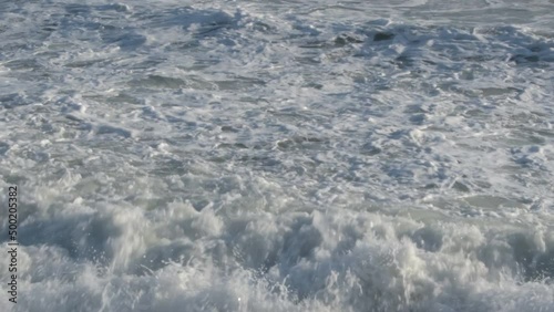 Rough waves sea entering with force at sunset photo