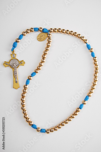 Male Christian rosary for prayer on a white background