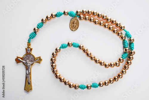 Male Christian rosary for prayer on a white background