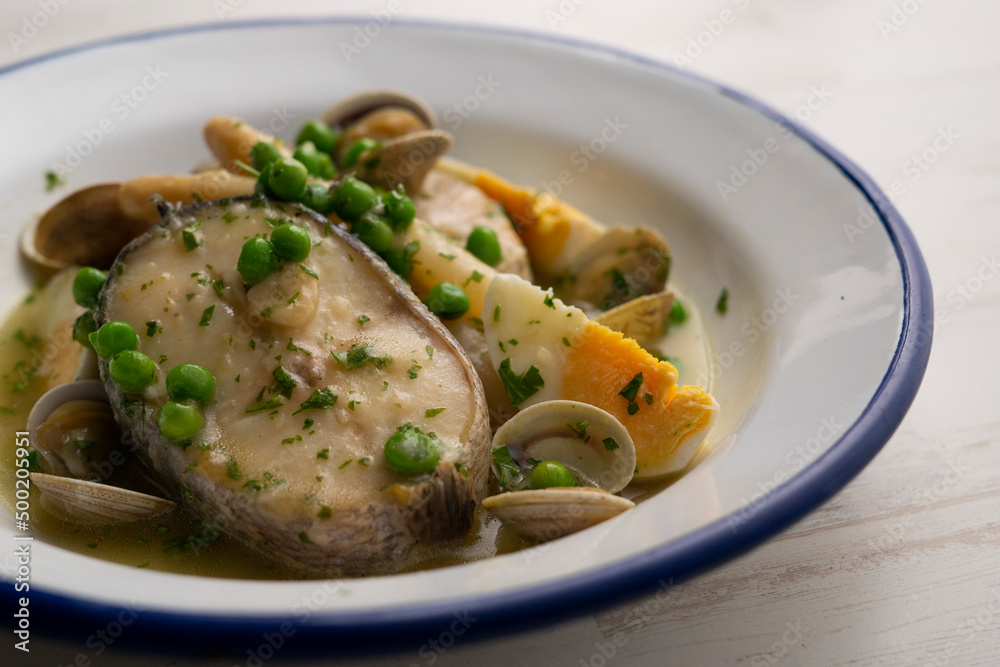 Basque hake with green sauce, asparagus, eggs and peas. Traditional Basque country tapas in the north of Spain. Basque hake with green sauce, asparagus, eggs and peas. Traditional Basque country tapas in the north of Spain.