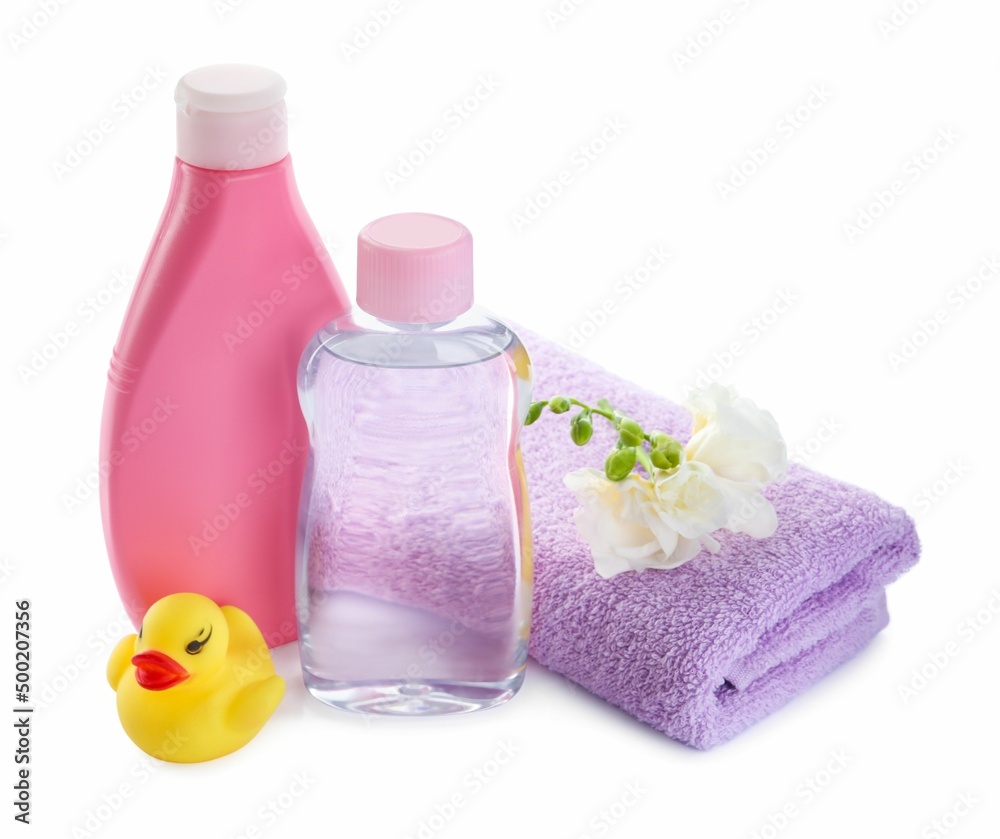 Baby oil, toiletries, flowers and toy duck on white background Baby oil, toiletries, flowers and toy duck on white background