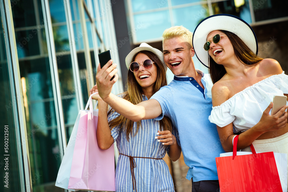 Group of young friends people doing selfie after shopping