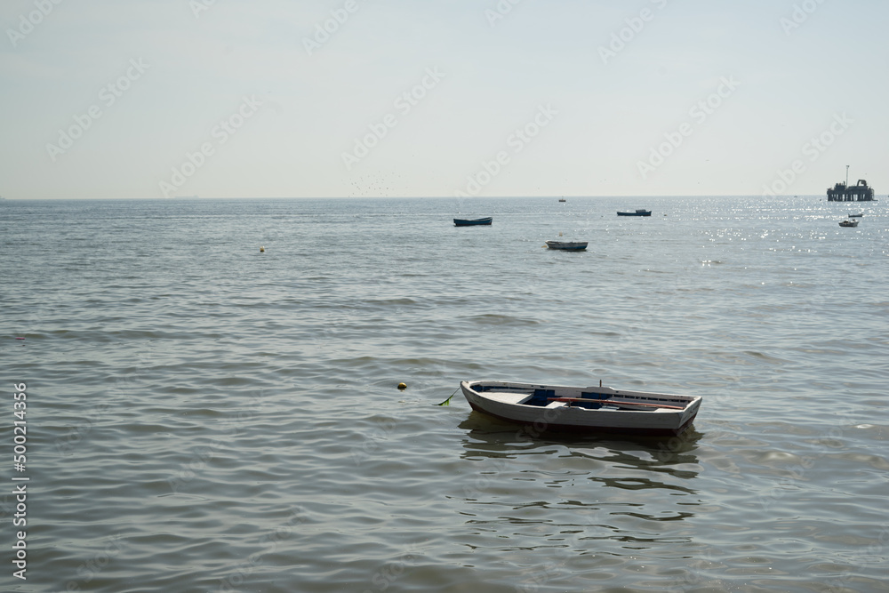 Single boat with sea and beach view with other boats on background Single boat with sea and beach view with other boats on background