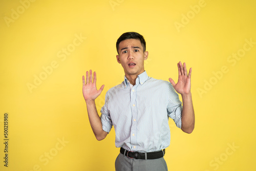 asian young young man with scared gesture on isolated background