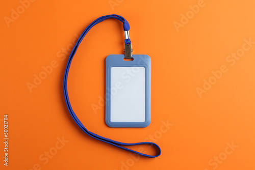 Blank badge on orange background, top view. Mockup for design