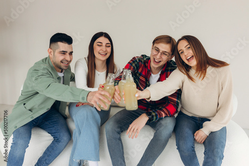 Friends toasting with beer on a home party