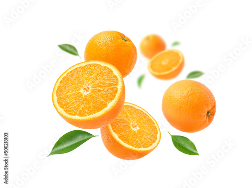 Orange with cut in half and leaves levitate isolated on white background.