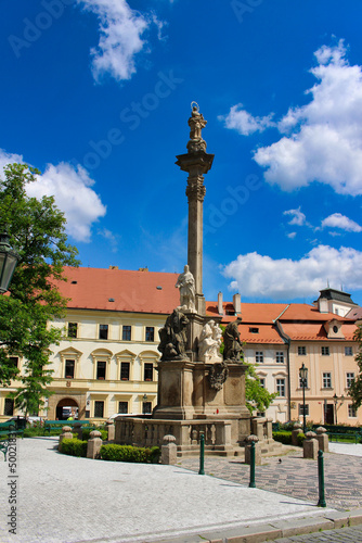 Sandstone Marian Plague Column in Hradčany. Prague town in summer cloudy day. Baroque architecture. Czech Republic.