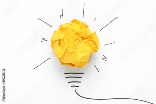 Creative composition with paper ball as lightbulb on white background, top view. Idea concept