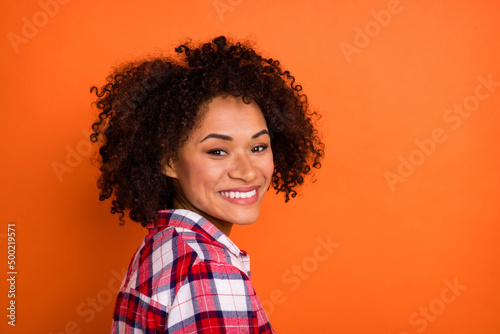 Profile photo of beauty young curly lady yell wear red shirt isolated on orange color background © deagreez