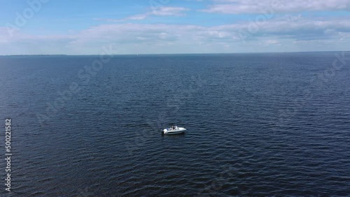 Wallpaper Mural A white pleasure boat is sailing at high speed along the Gulf of Finland on a summer day. Motor boat. Blue sky. Sunny weather. aerial view of a speedboat Concept of sea travel and recreation Torontodigital.ca