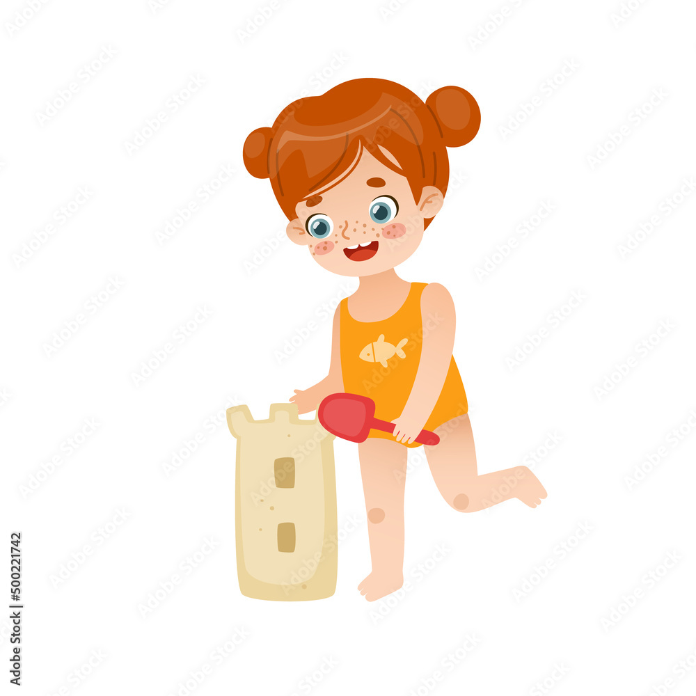 Cute girl building sand castle on the summer vacations. Baby girl with freckles and red hair playing with the sand on the beach.