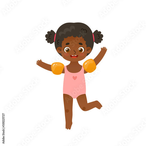 Adorable baby girl jumping with inflatable armbands. Funny african american girl on summer vacations.