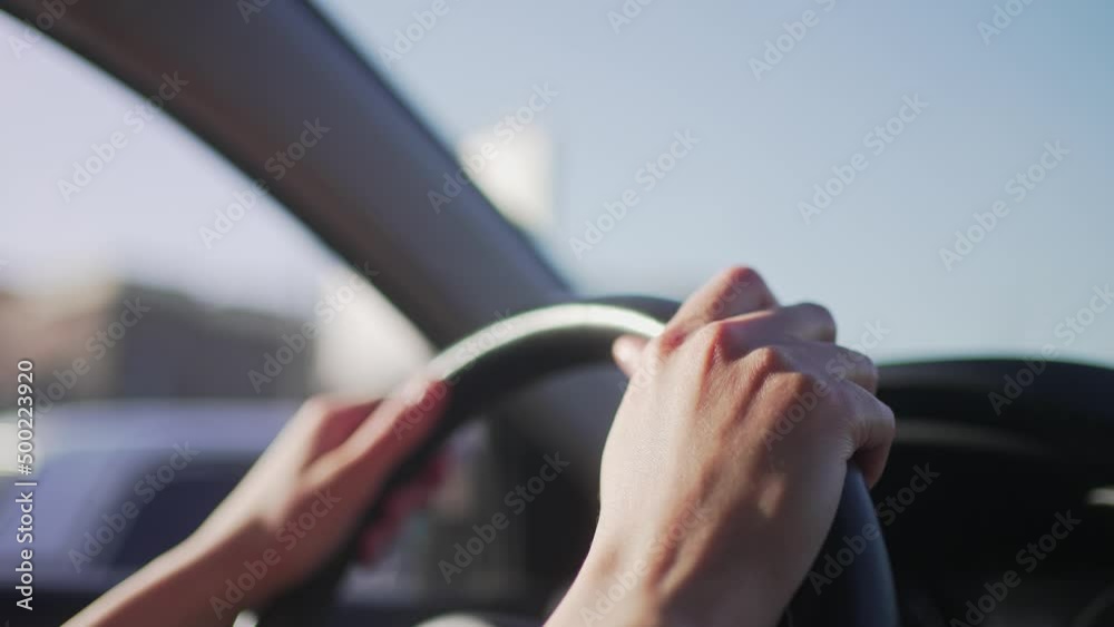 Hands of the female driver on the steering wheel of the car. Traffic control in motion, close-up 4K 10 BIT Hands of the female driver on the steering wheel of the car. Traffic control in motion, close-up 4K 10 BIT