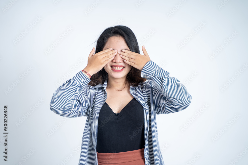 Asian woman closing eyes with both palms on isolated background Asian woman closing eyes with both palms on isolated background