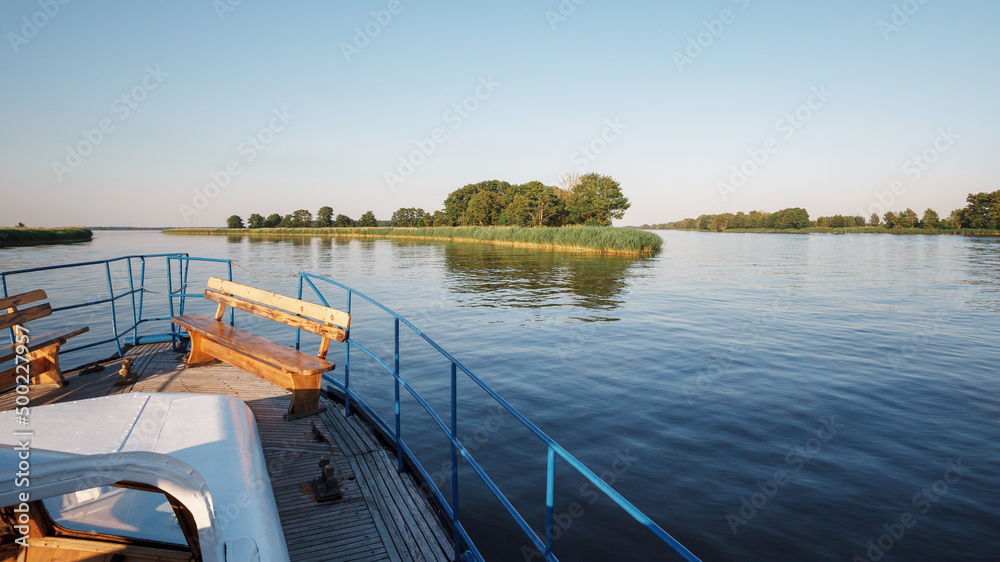View from the front deck of the ship to a branching river on a quiet summer evening.