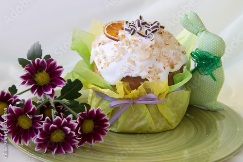 Easter cake with decor and flowers on a green plate