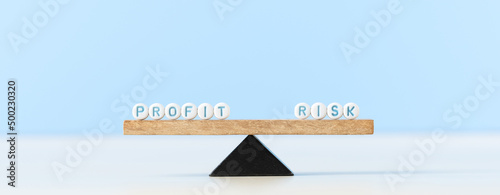Risk and profit words on scale. Risk management concept and a risk reward ratio return of an investment.
