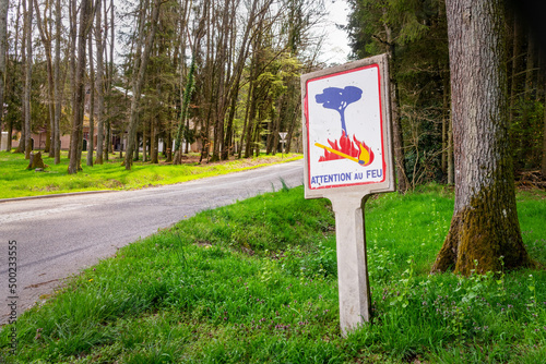 Attention au feu (caution fire hazard), vintage old french roadsign in woods