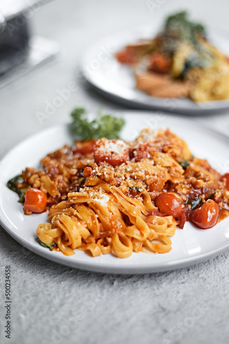 Pasta, spaghetti with tomato sauce on a light background