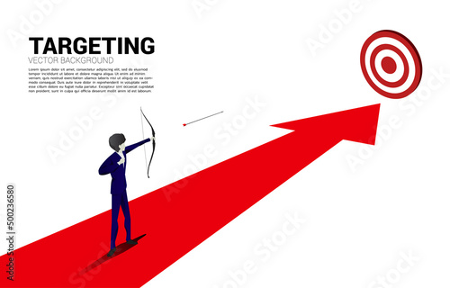 Businessman in suit shoot the arrow to target . Business Concept of marketing target and customer. © Panithan