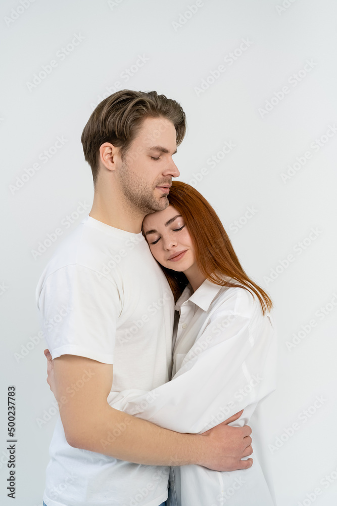 Redhead woman hugging boyfriend isolated on white. Redhead woman hugging boyfriend isolated on white.