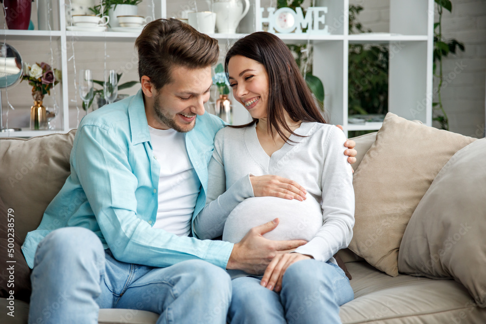 Couple expecting a baby while husband caresses the belly of his pregnant woman.. Couple expecting a baby while husband caresses the belly of his pregnant woman..