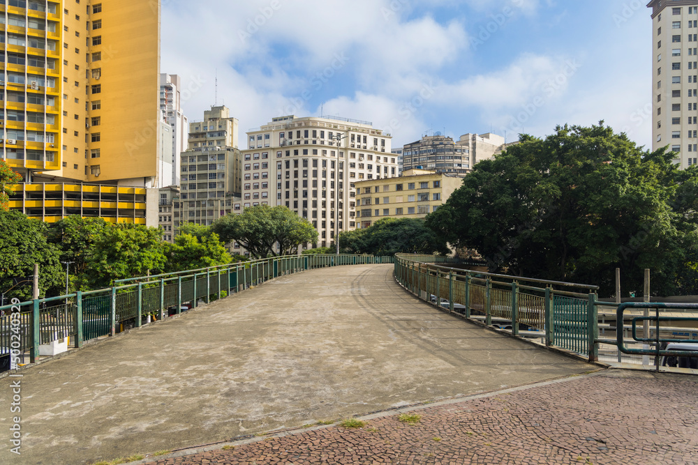 Footbridge with buildings in downtown Sao Paulo in the background, Bandeira bus terminal' Footbridge with buildings in downtown Sao Paulo in the background, Bandeira bus terminal'