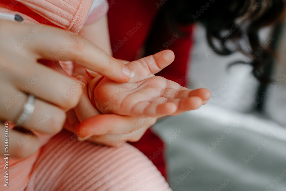 Fototapeta premium mother caressing the little cute hand of her daughter. High quality photo
