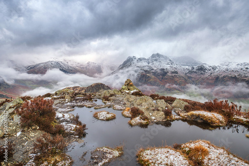 Obraz na płótnie Atmospheric winter view of stormy weather on Lake District fells with snow on th