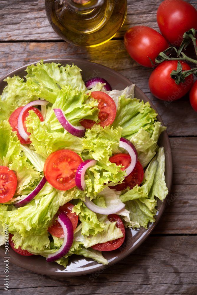 Delicious vegetable salad with lettuce, tomatoes and onions Delicious vegetable salad with lettuce, tomatoes and onions