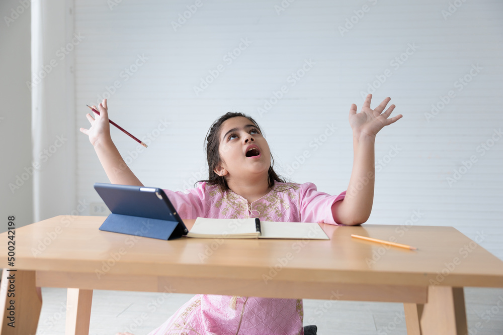 cute Indian girl smiling and raise hands pose after finished online learning class, education concept cute Indian girl smiling and raise hands pose after finished online learning class, education concept